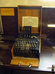 An Enigma machine with the three scrambling rotors at the top and Steckerbrett (plugboard) on the bottom front edge.

Kindly ignore the anorak in the reflection of the glass case.