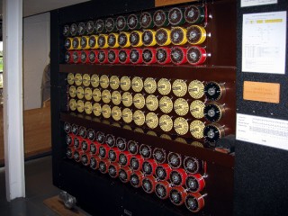 The front of the rebuilt bombe.
These were used to help decrypt messages generated by the Enigma machine. Each drum performs the equivalent function of one of the rotors in an Enigma machine, hence the grouping in threes (one for each of the rotors in a three-rotor Enigma). The bombe could perform the same task as thirty-six Enigmas running in parallel, and was driven by an electric motor to quickly step through all of the different rotor positions.
