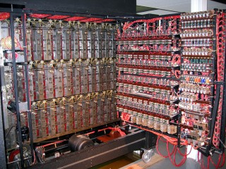 The inside of the opened bombe, showing some of the mechanical detail behind the drums to the left (with the electric motor at the bottom) and some of the electronic detail in the door to the right.
A bombe apparently contained approximately five miles of wiring.