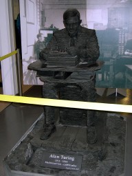 This slate statue of Alan Turing sits near the bombe that he designed.