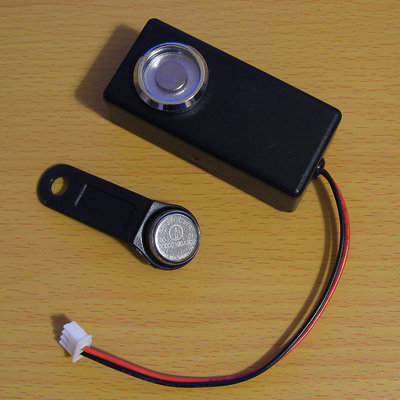 Photo of a TM1990A iButton on a fob with a probe to read it with