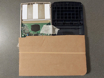 Photo of the inside of the EL-9900 held open with two pieces of cardboard and an elastic band