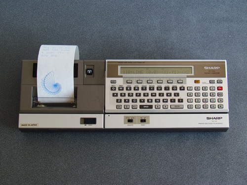 Photo of Sharp PC-1500 Pocket Computer connected to the CE-150 Printer and Cassette Interface